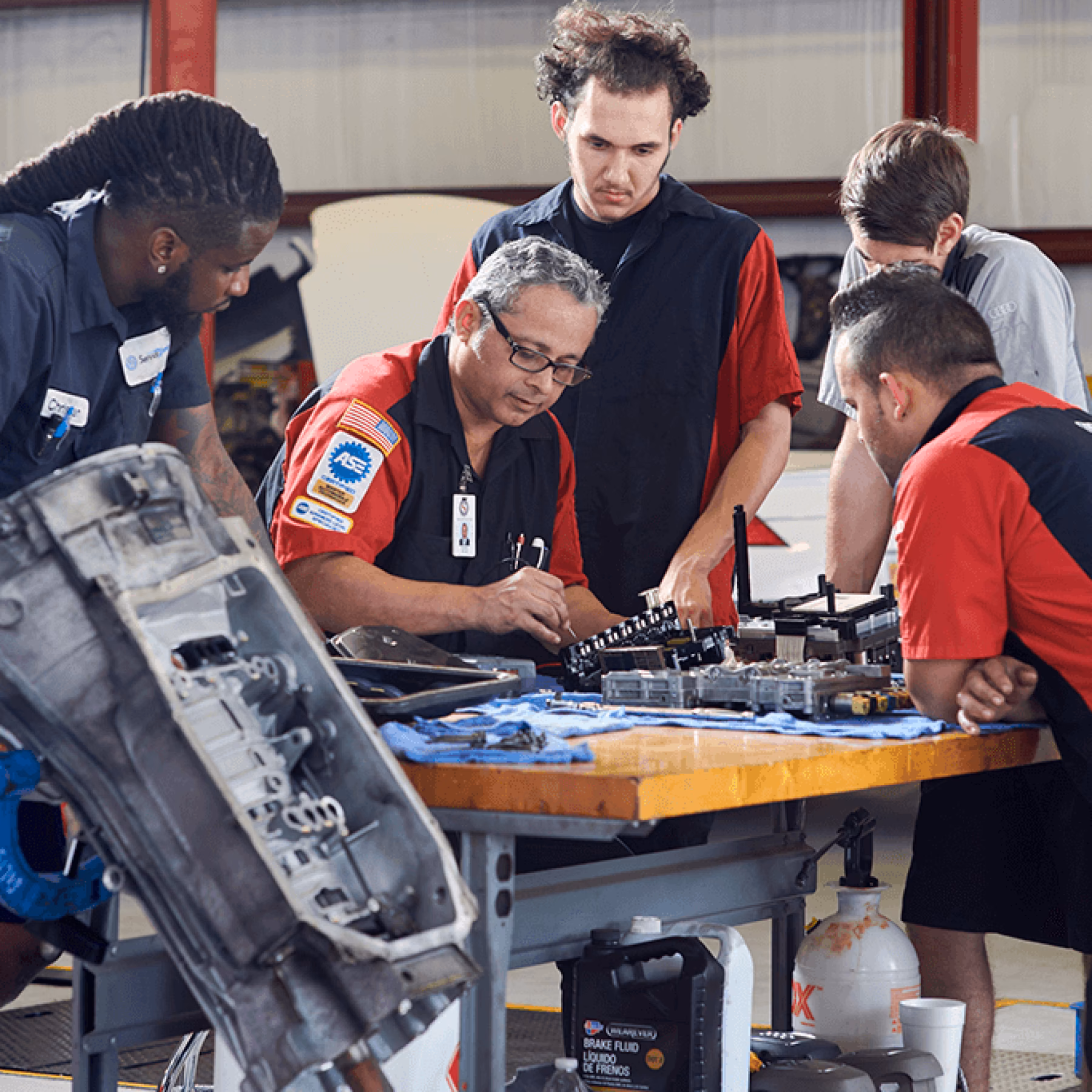 Why do Audi employees need special training & development programs?